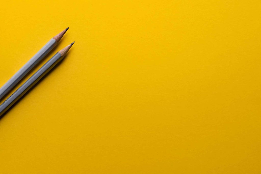 pen on yellow background